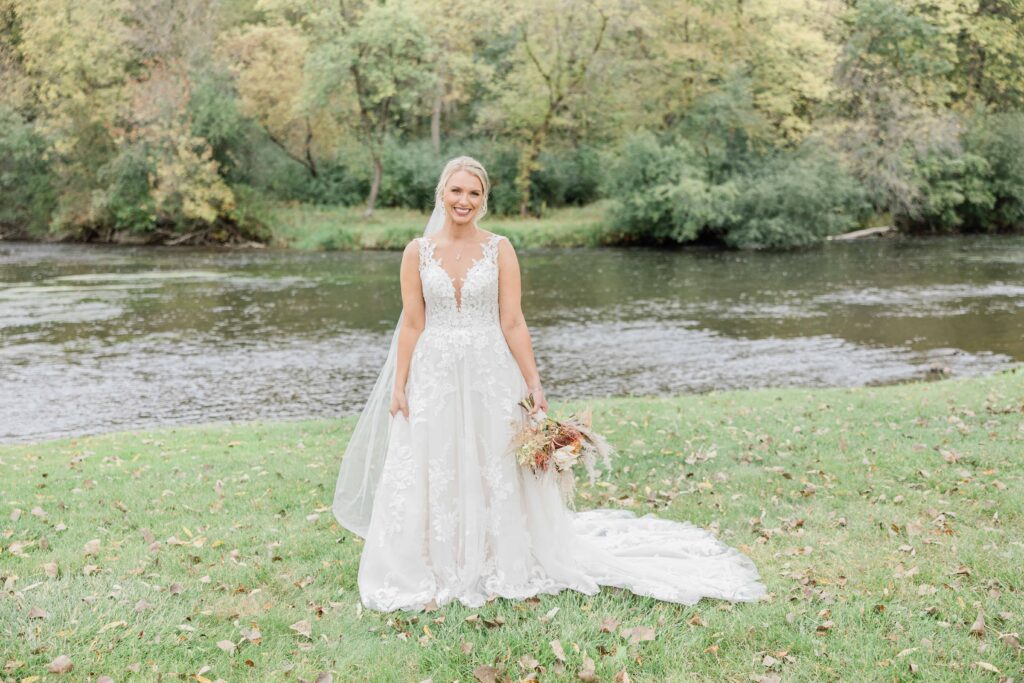 Bride posing along the Apple River in Somesert Wisconsin at La Pointe Events. 