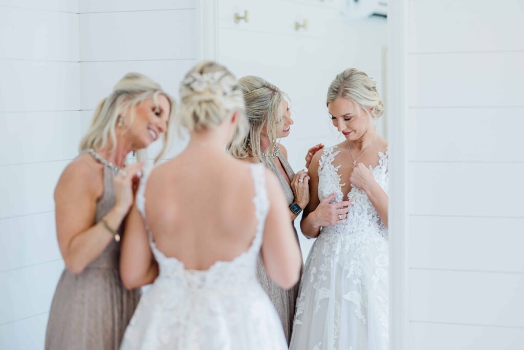 Getting ready photos of Casey on her wedding day. A bridal moment of Casey on her wedding day. A beautiful intimate moment between the bride and her mom helping zip up her dress. photo taken by Isa Wines Photography at La Pointe Events, Somerset Wisconsin. 
