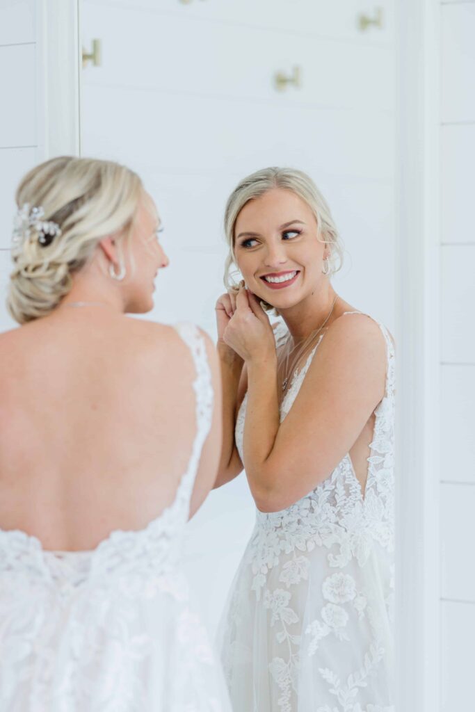 A bridal moment of Casey on her wedding day. A beautiful intimate moment between the bride and her mom helping zip up her dress. photo taken by Isa Wines Photography at La Pointe Events, Somerset Wisconsin. 