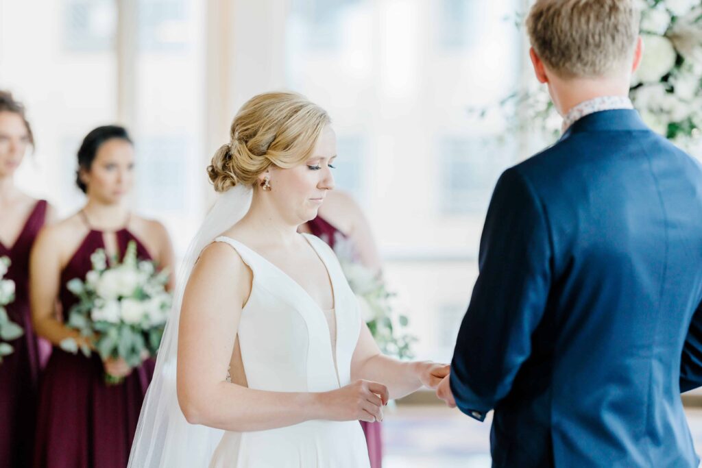 Gorgeous Fall wedding at the Intercontinental Hotel in Saint Paul, Minnesota. This is a portrait of the ceremony bride exchanging the ring. 